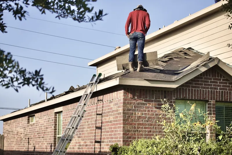 Professional roofer working on a residential roof in Cheswold